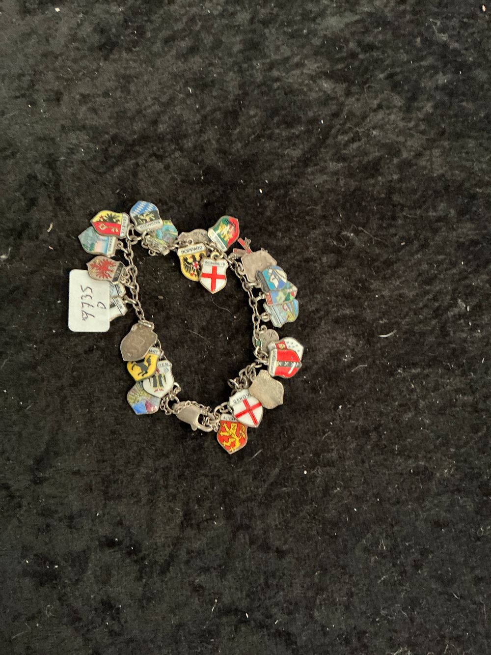 Lot 201: A Vintage European Souvenir Enamel Shield Charm Bracelet