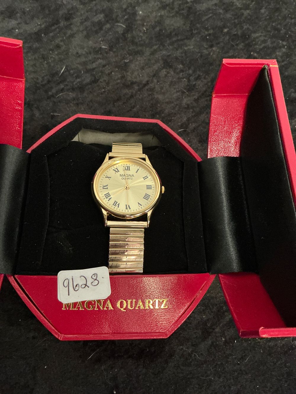 Lot 219: A Magna Quartz Gold-Tone Dress Watch with Expansion Bracelet and Original Box