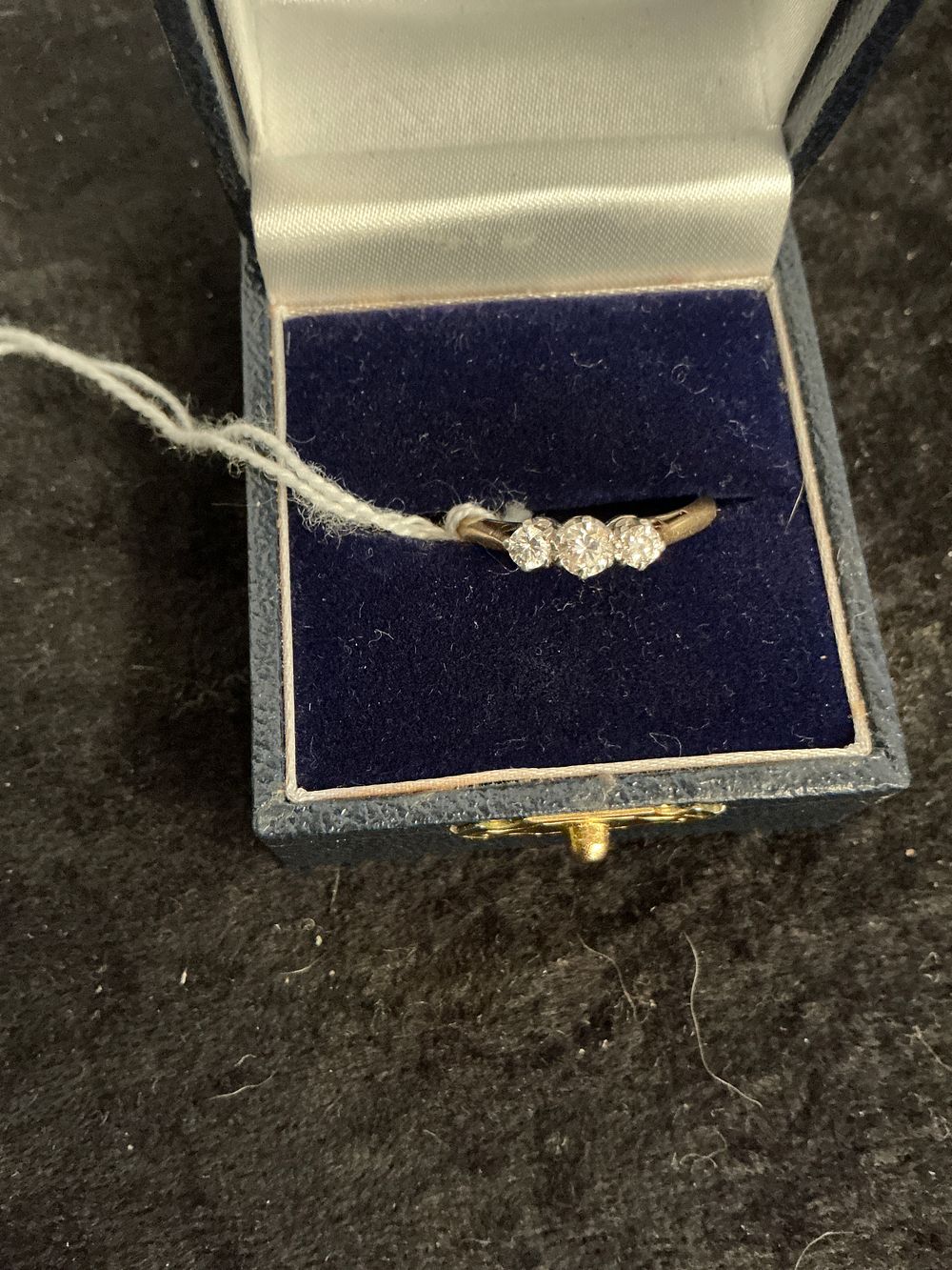 Lot 223: An 18 carat gold and diamond three-stone trilogy ring size m