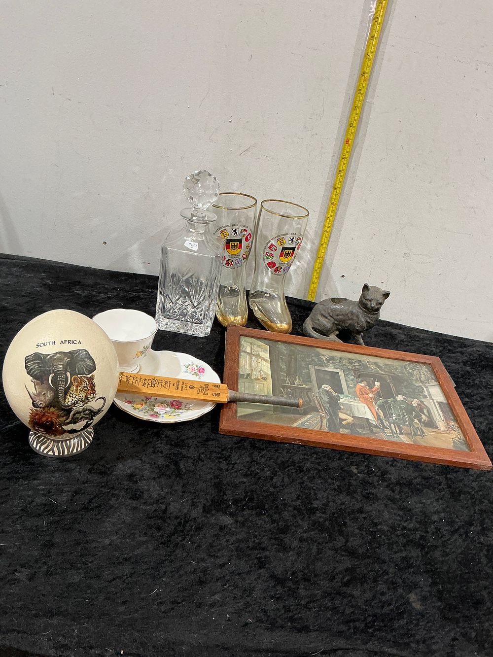 Lot 403: A Collection of Decorative and Souvenir Items including a Cut-Glass Decanter, German Beer Boots, and a Framed Print