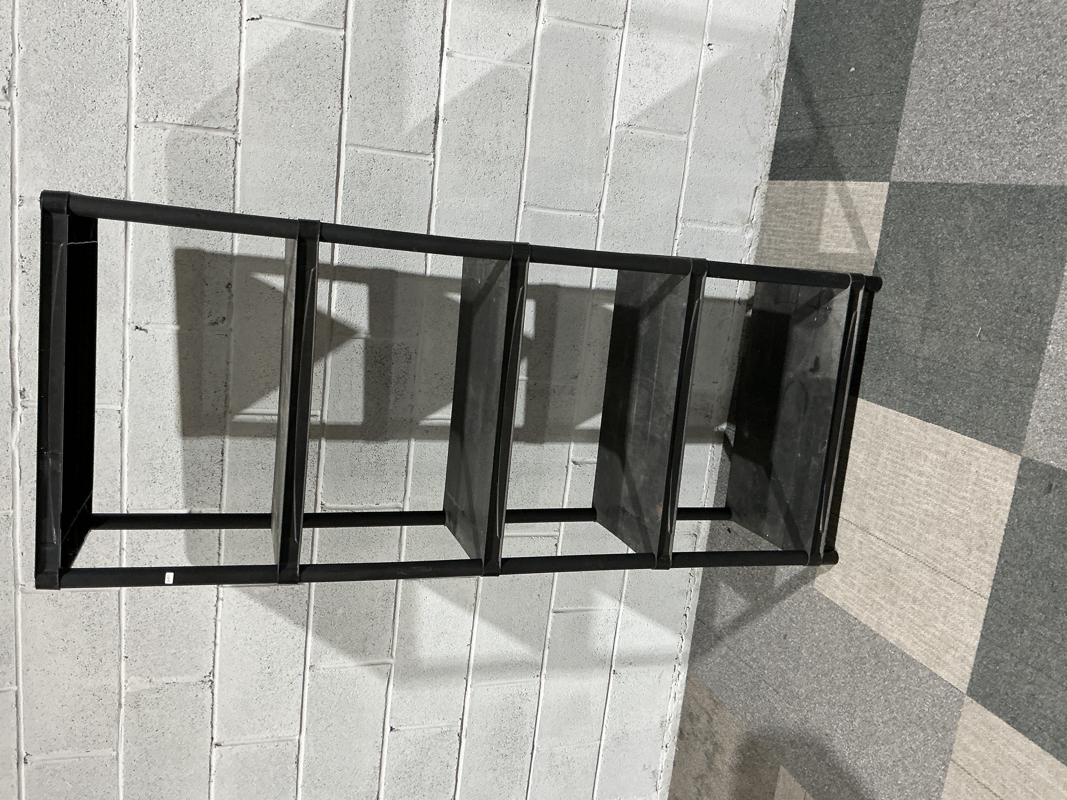 A Four-Tier Modular Black Plastic Storage Shelving Unit
