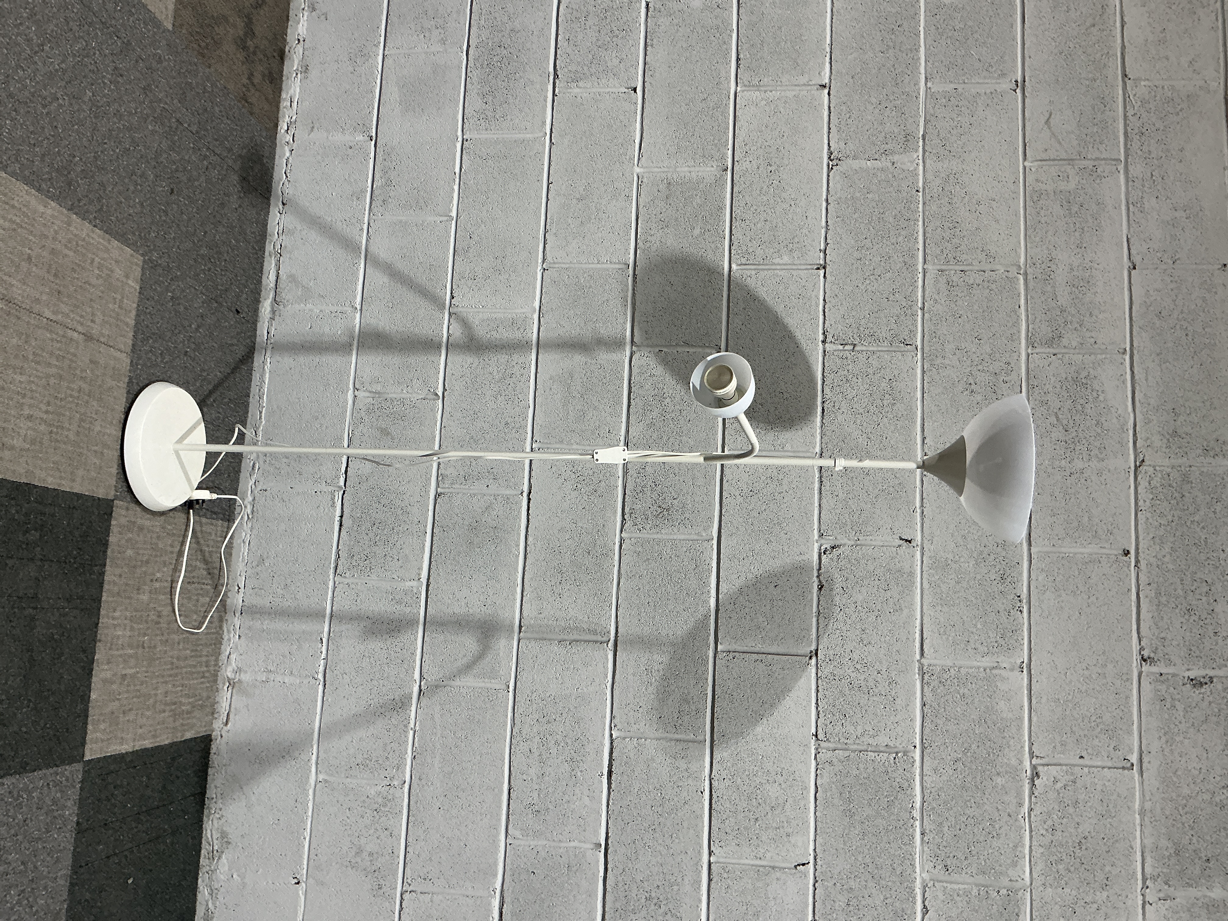 A contemporary white metal twin-light floor lamp