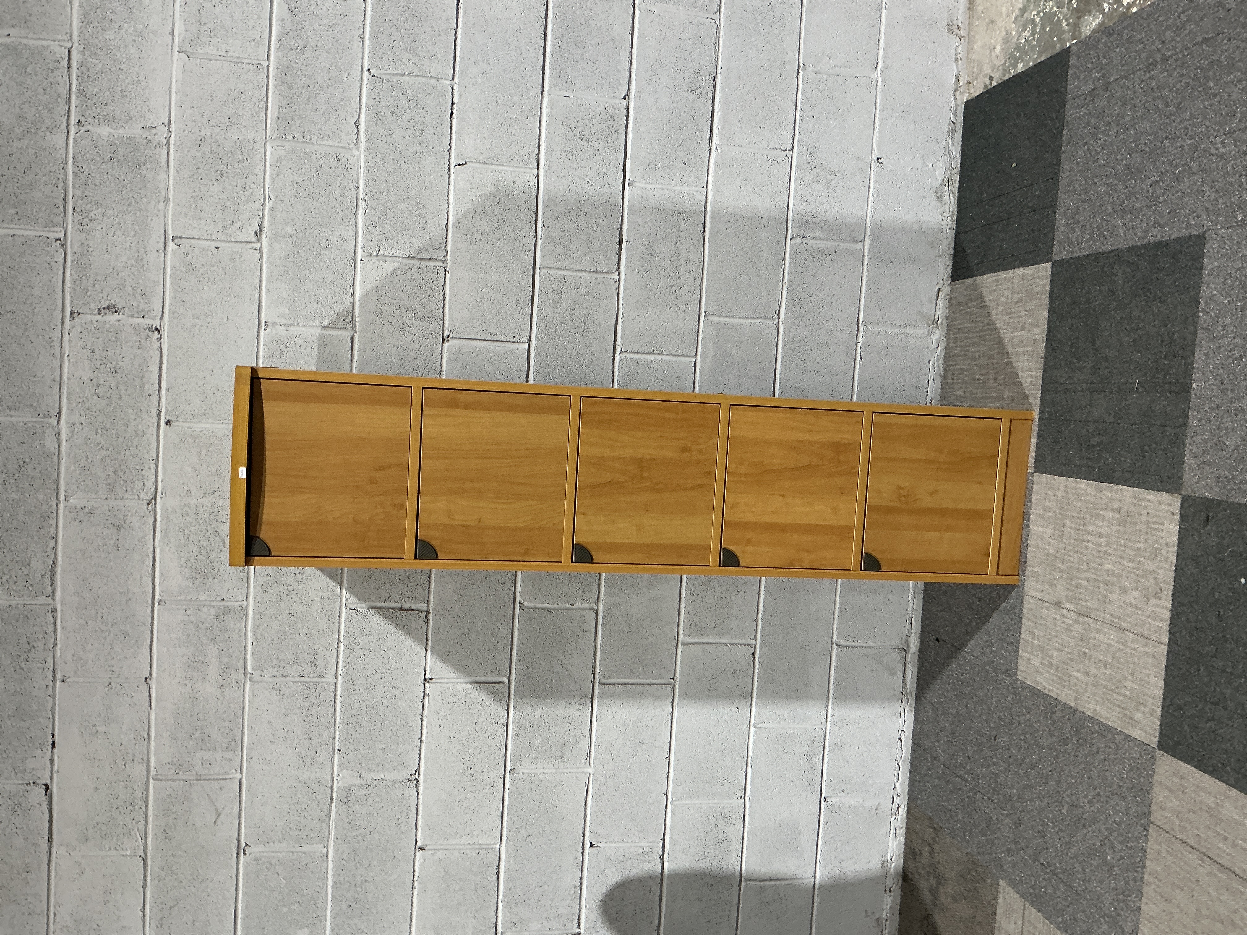A contemporary five compartment oak effect storage/locker unit