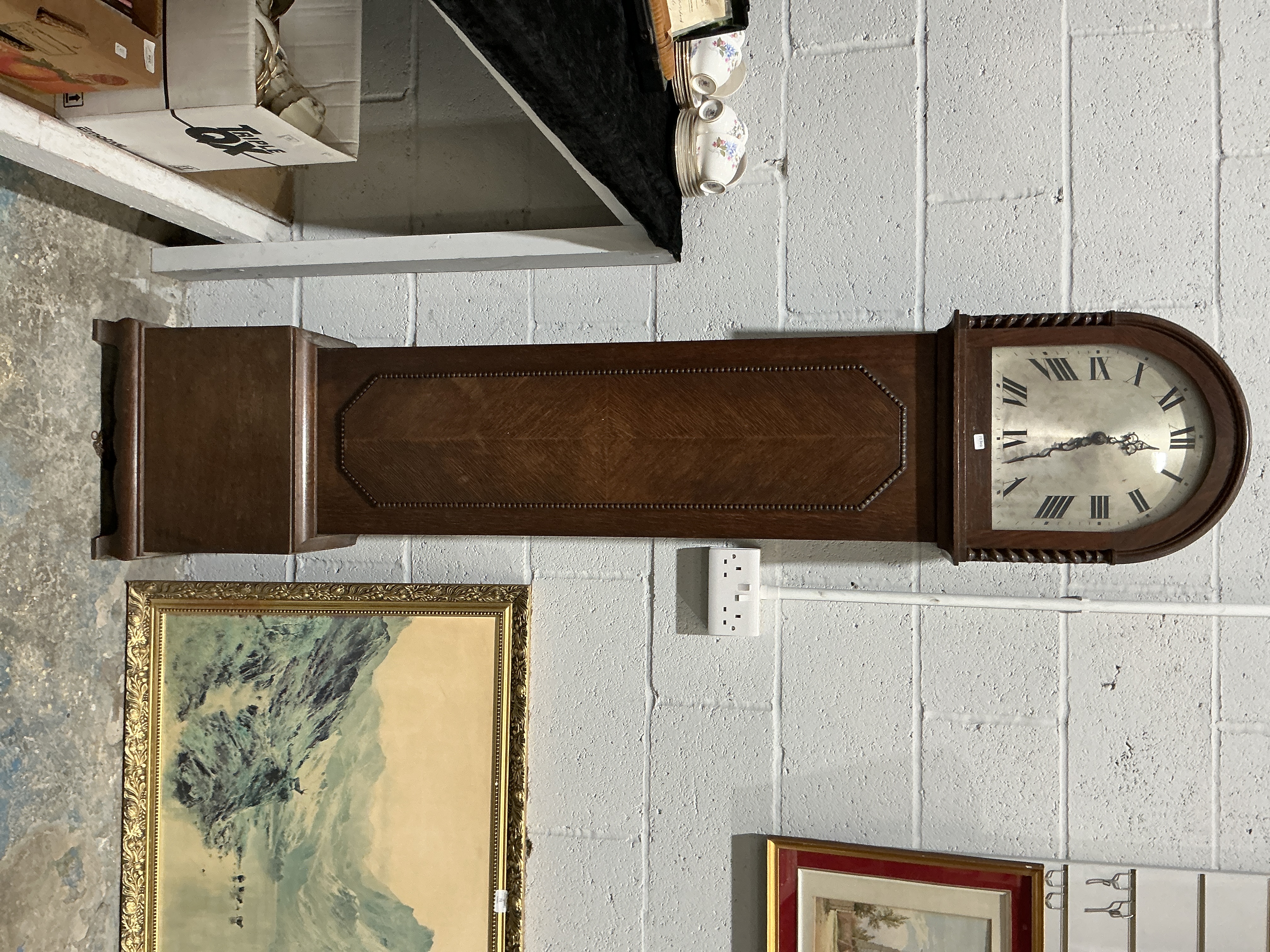 An early 20th-century oak longcase clock