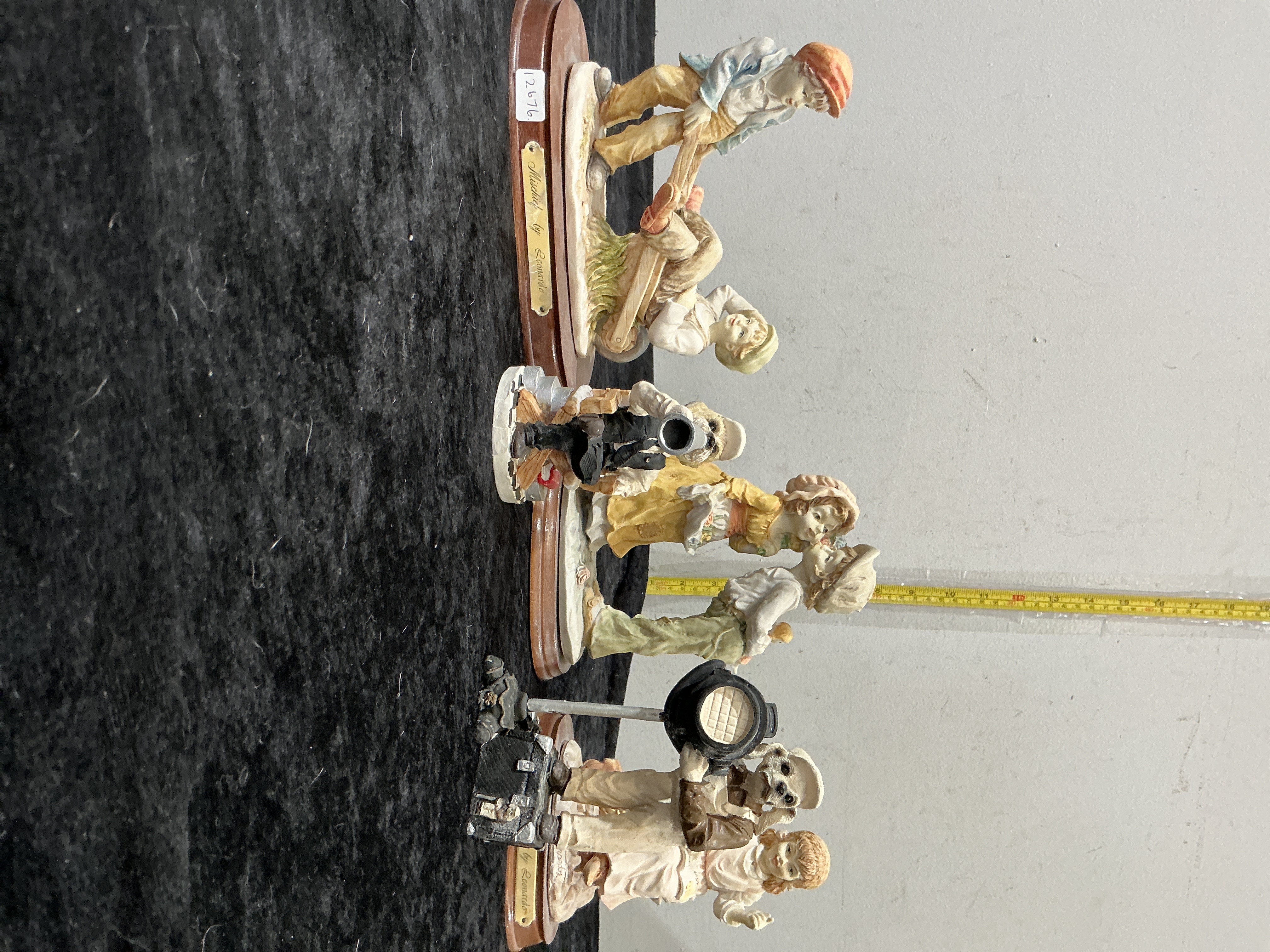 A Collection of Four Leonardo Collection Hand-Painted Resin Figurines on Wooden Bases