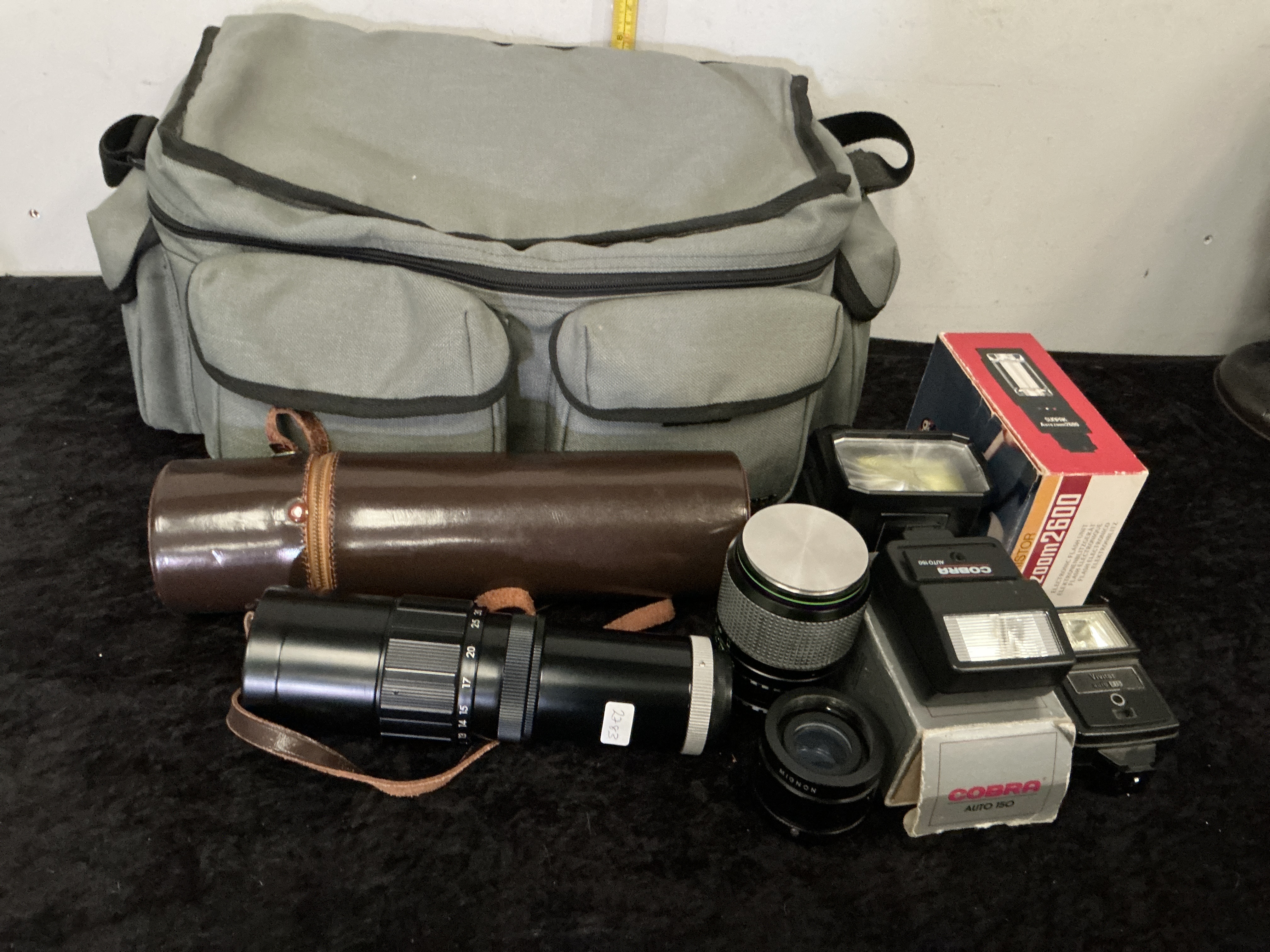 A Collection of Vintage Photographic Lenses, Electronic Flash Units, and Accessories