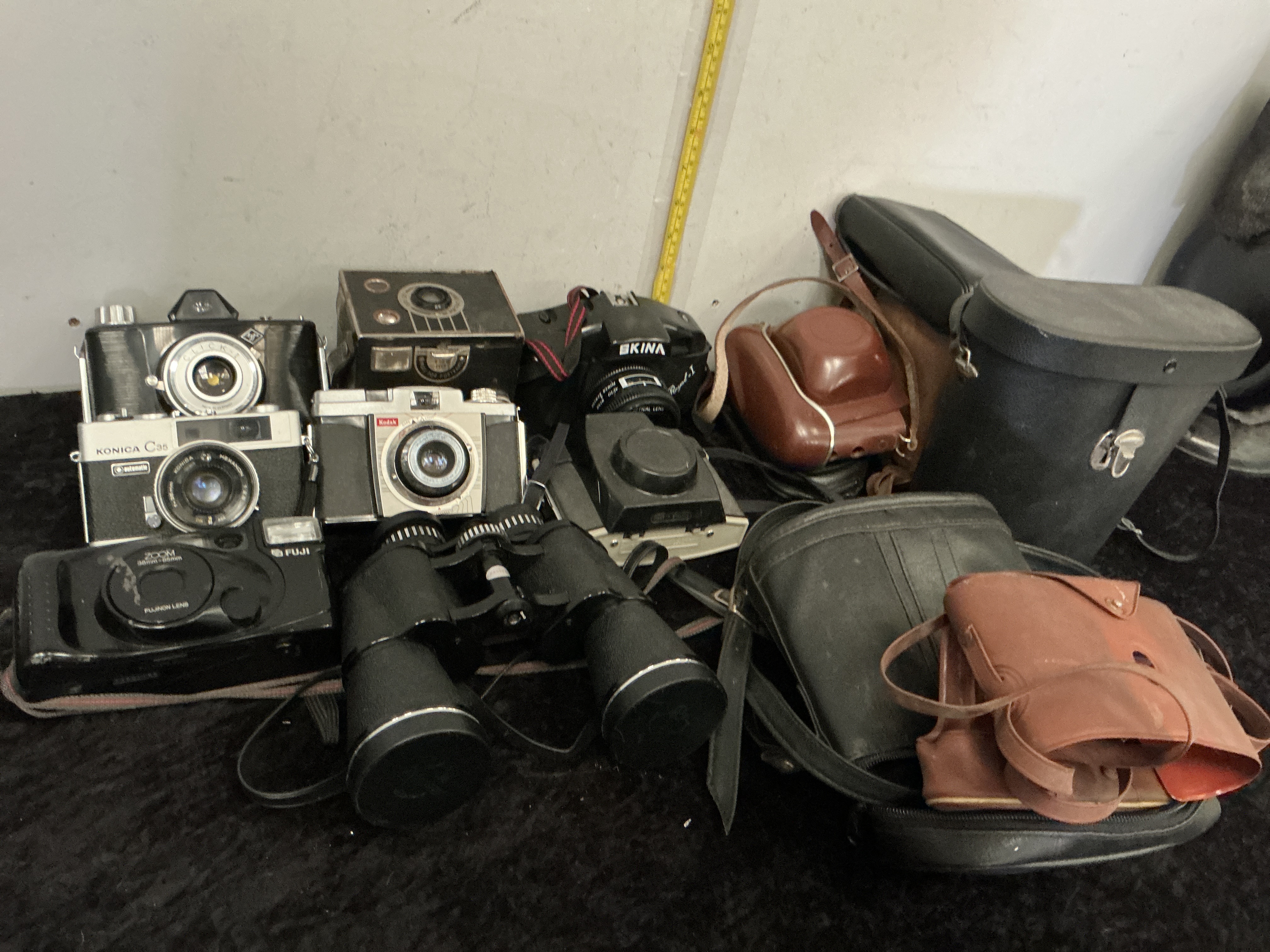An Assortment of Vintage Cameras, Binoculars, and Photographic Accessories