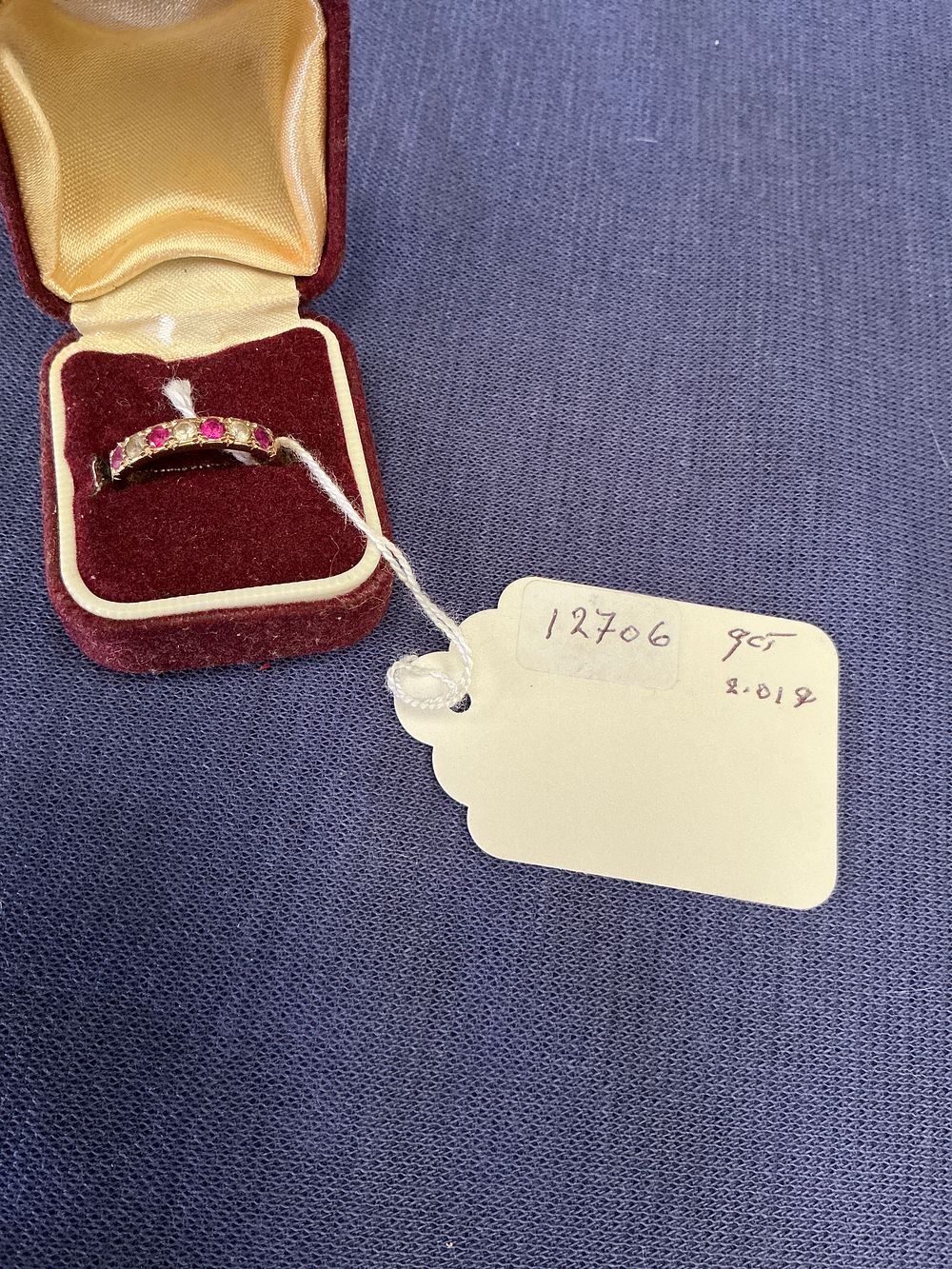 Lot 306: A Victorian 9 Carat Gold Ruby and Seed Pearl Five-Stone Ring