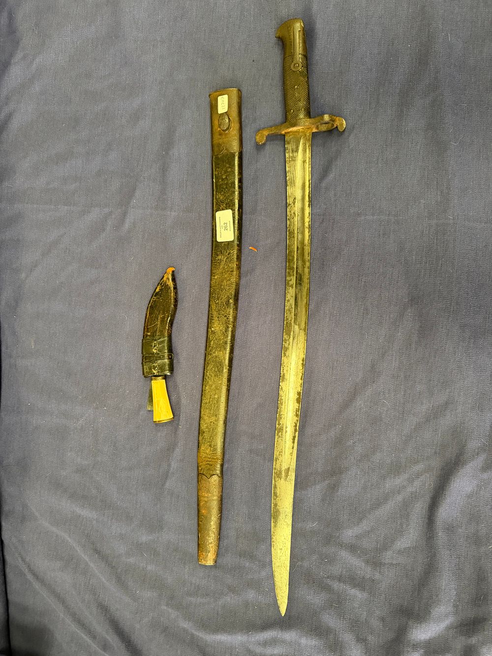 Lot 262: Two edged weapons comprising a 19th-century yataghan-style sword bayonet and a utility knife