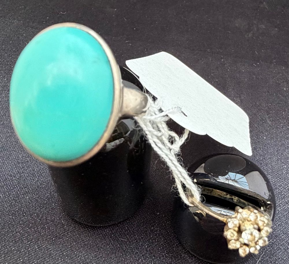 Lot 263: Two silver rings comprising a turquoise cabochon statement ring and a clear stone cluster ring