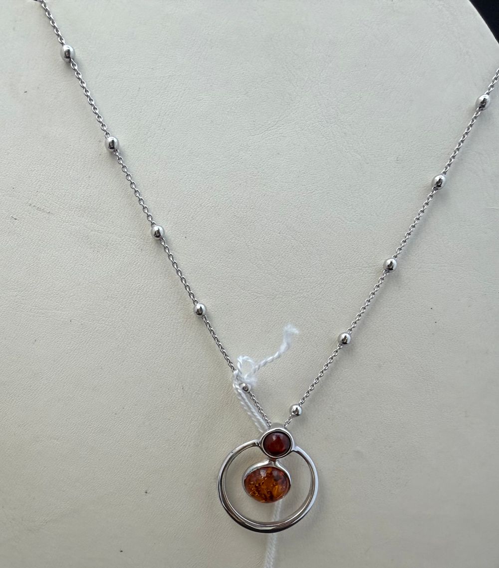 Lot 281: A Silver and Amber Circle Pendant Necklace