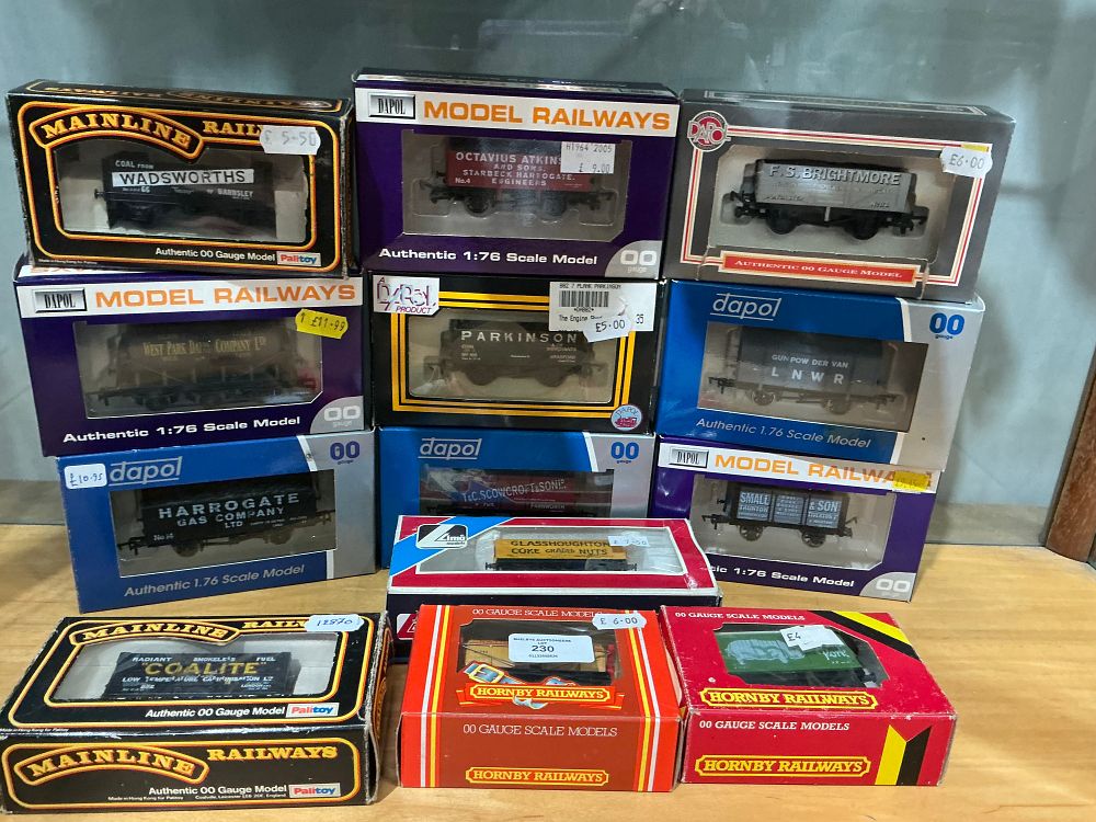 Lot 230: A Collection of OO Gauge Model Railway Freight Wagons and Vans by Dapol, Mainline, Hornby, and Lima
