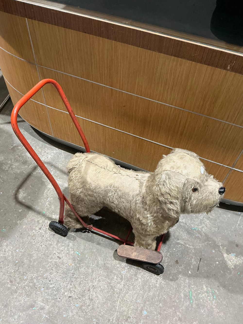 Lot 234: A Vintage Plush Push-Along Toy Dog on a Red Metal Frame
