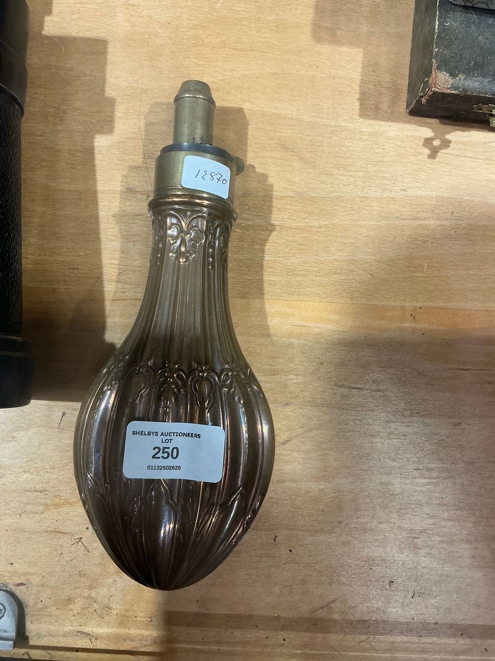 Lot 250: A nineteenth-century embossed copper and brass powder flask