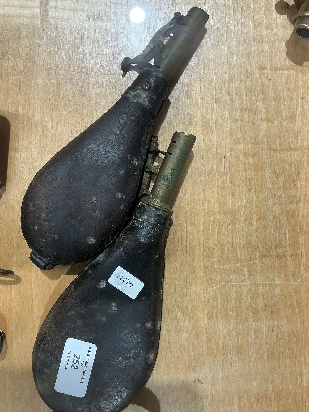 Lot 252: Two 19th Century Leather and Brass Shot Flasks