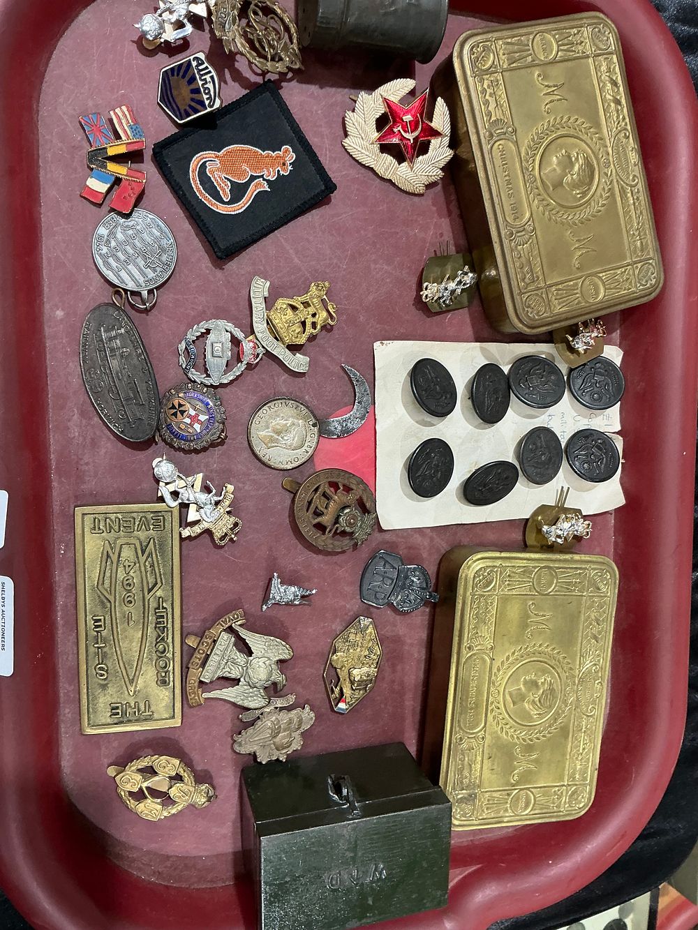 Lot 254: A Collection of British and International Militaria and Commemorative Badges including Princess Mary 1914 Christmas Tins