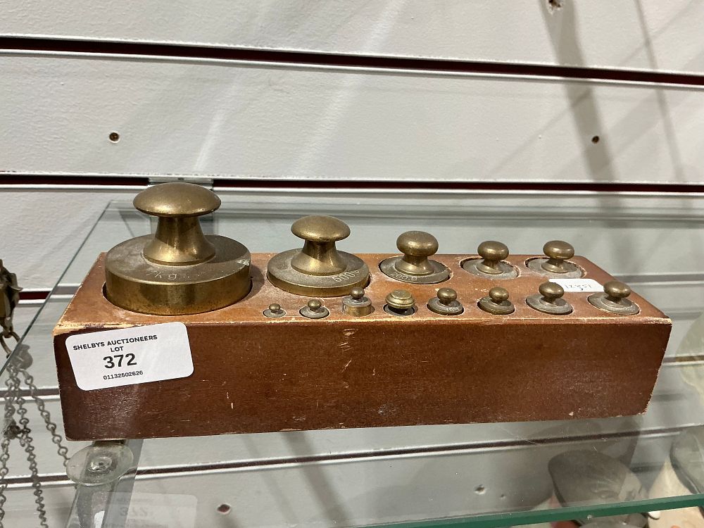 Lot 372: A Set of Brass Metric Weights in a Fitted Wooden Block