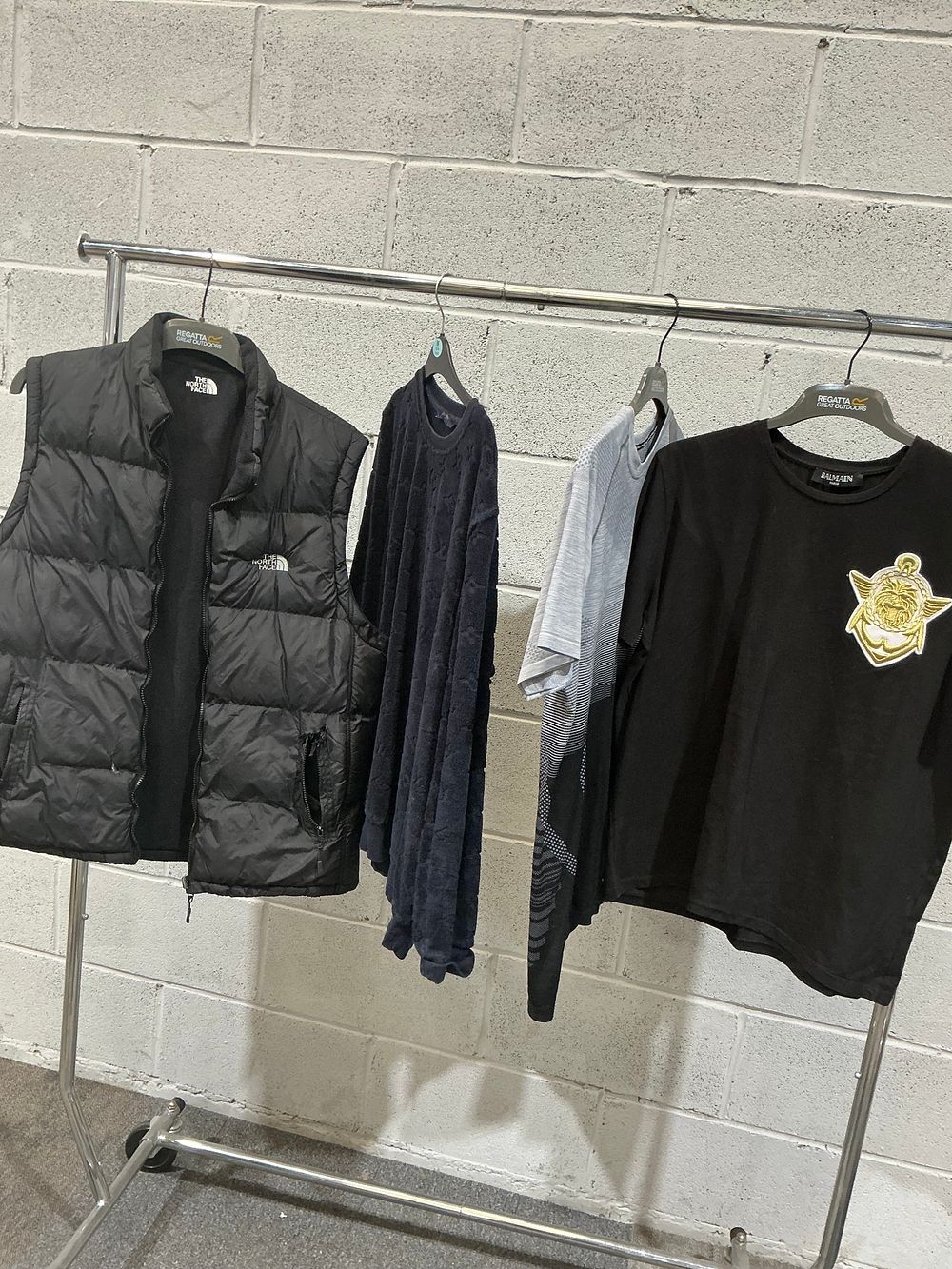 Lot 316: A Collection of Men's Apparel Including Balmain and The North Face inspired designs