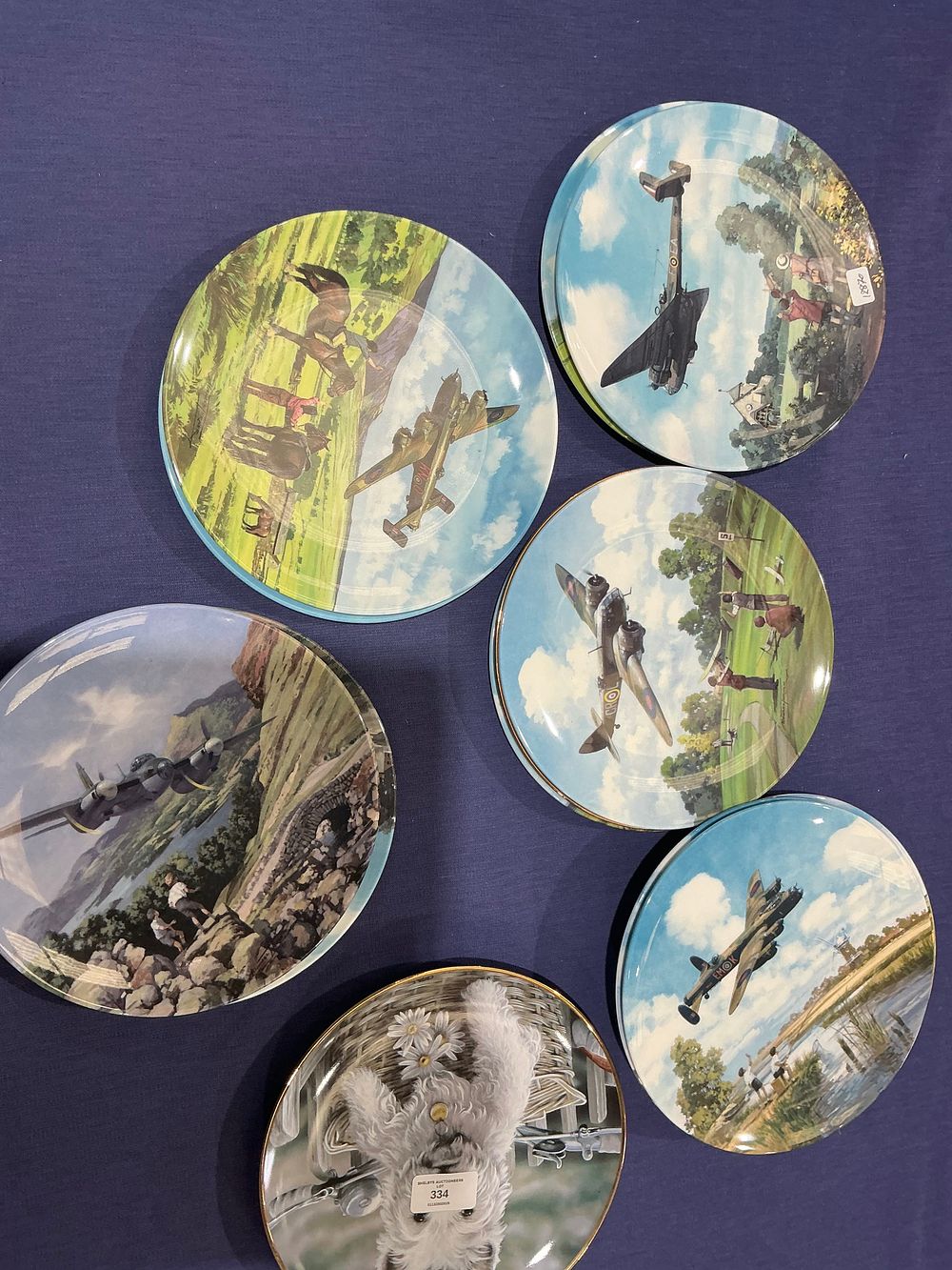 Lot 334: A Group of Ceramic Commemorative Plates Depicting World War II Aircraft and a Terrier