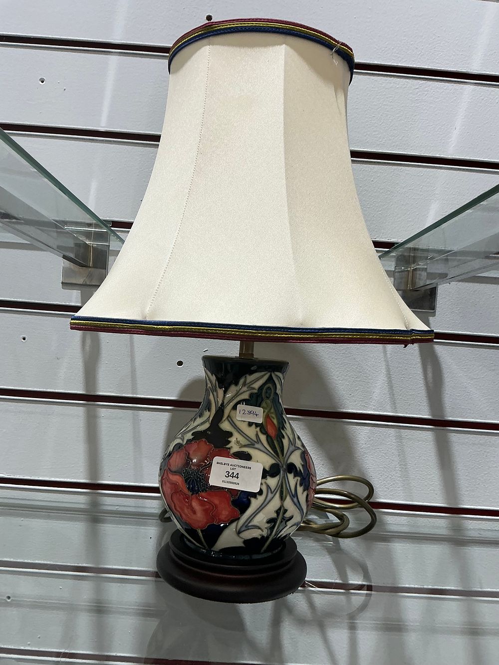 Lot 344: A Moorcroft pottery table lamp in the poppy pattern with shade