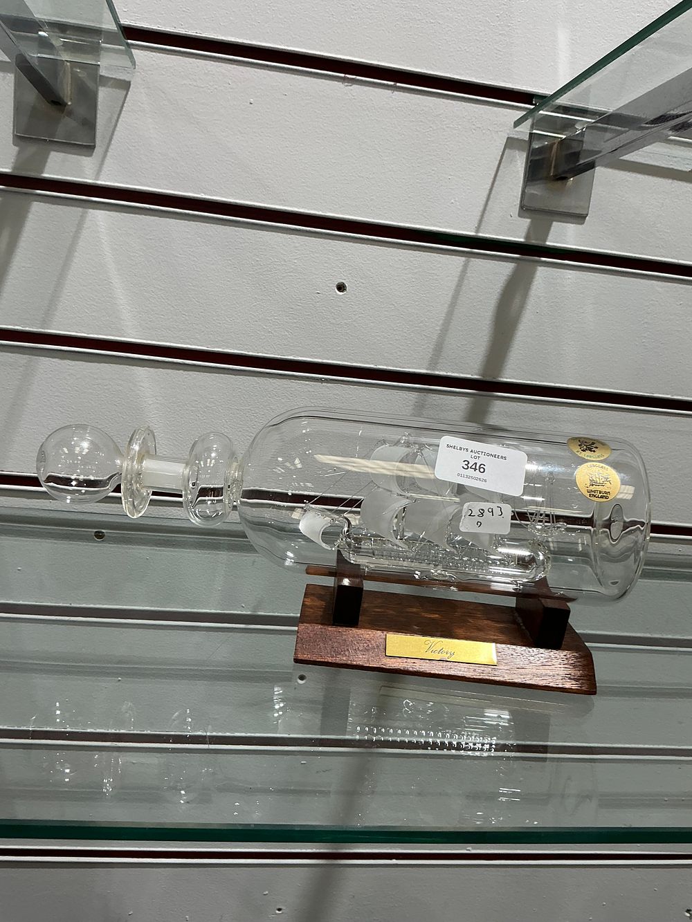 Lot 346: A contemporary Scottish glass ship-in-a-bottle sculpture of HMS Victory on a wooden stand