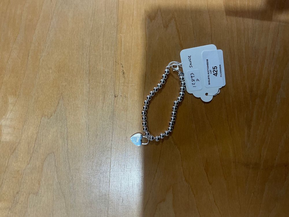 Lot 425: A Sterling Silver Bead Bracelet with Heart Charm