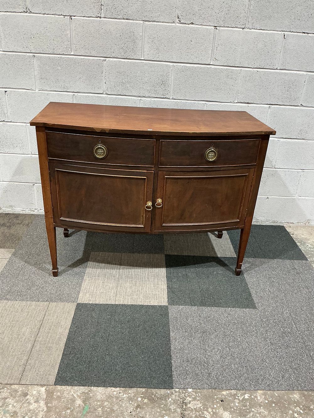 Lot 28: A Hepplewhite Style Mahogany Finished Bow Front Sideboard