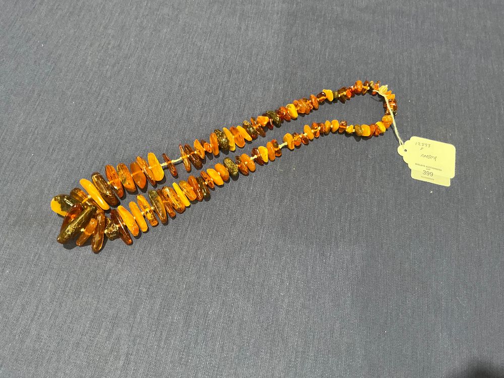 Lot 131: A Graduated Amber Bead Necklace
