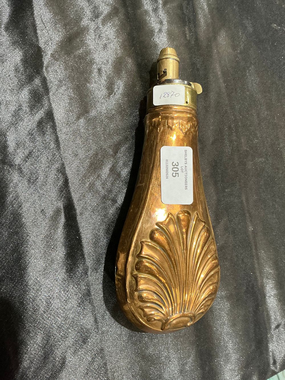 Lot 133: A 19th-Century Copper and Brass Powder Flask with Embossed Shell Design