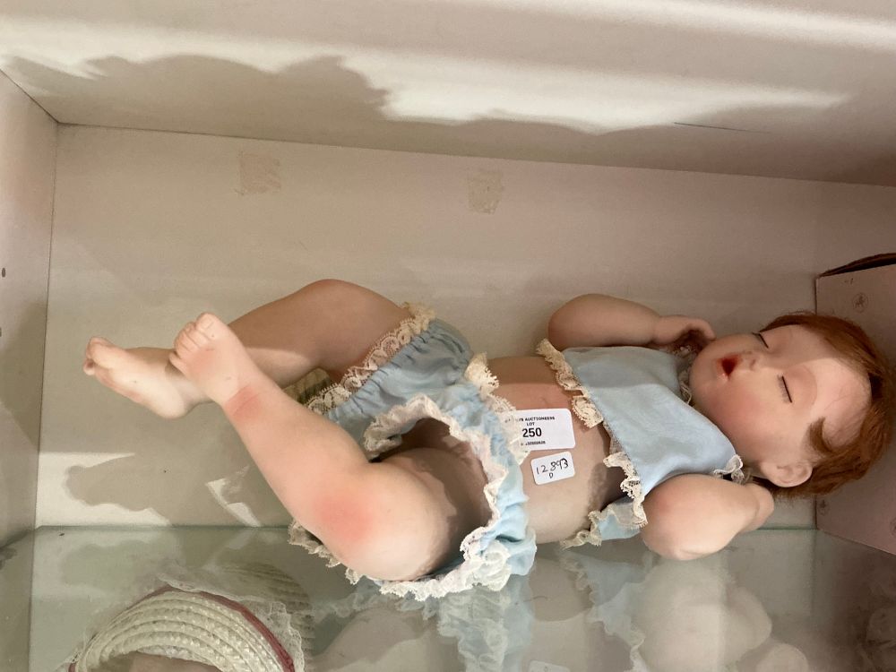 Lot 208: A collector's sleeping baby doll with a two-piece outfit