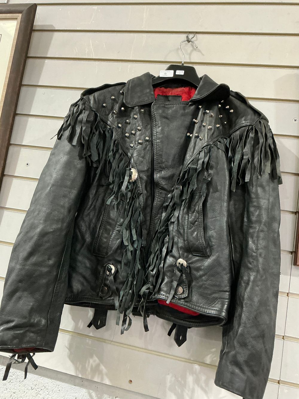 Lot 190: A black leather Western-style biker jacket with fringe and silver-toned stud detailing size large