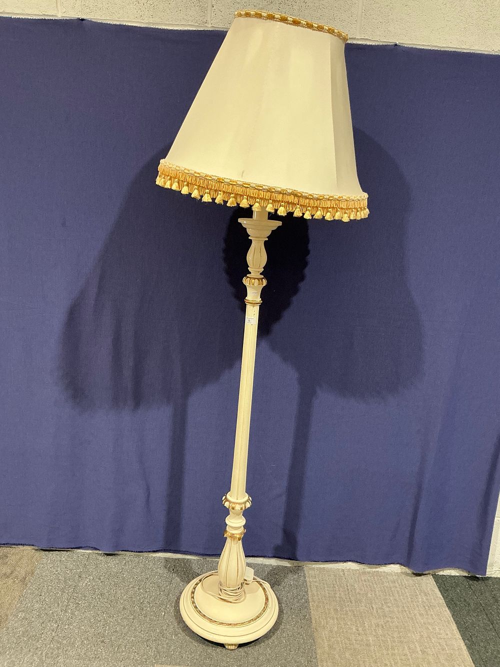 Lot 39: A Gilt and Cream Painted Wooden Standard Lamp with Fringed Shade