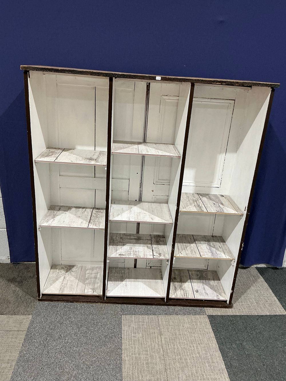 Lot 86: Rustic Painted and Paper-Lined Wooden Ten-Compartment Pigeonhole Bookcase
