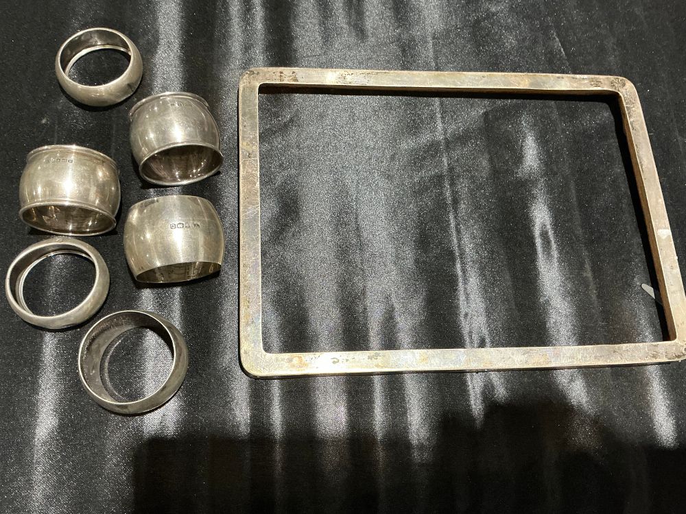 Lot 119: A Collection of Sterling Silver Napkin Rings and a Silver Mounted Photograph Frame
