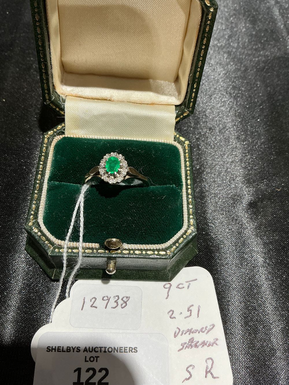 Lot 122: A 9 Carat Gold Emerald and Diamond Cluster Ring 2.51 gram size R