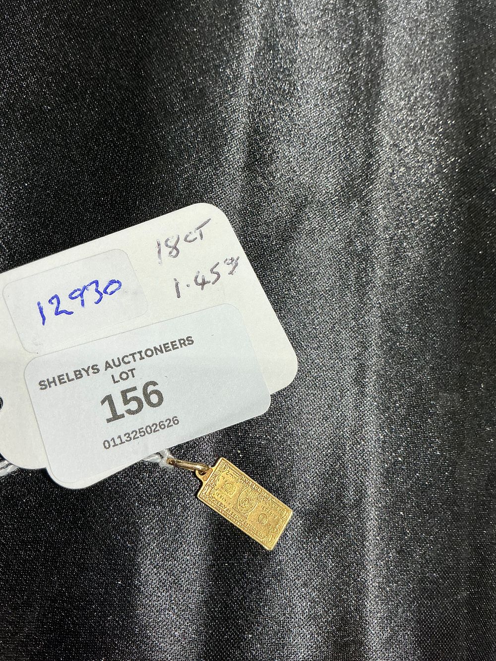 Lot 156: An 18 Carat Yellow Gold Miniature US One Dollar Bill Pendant 1.45 gram