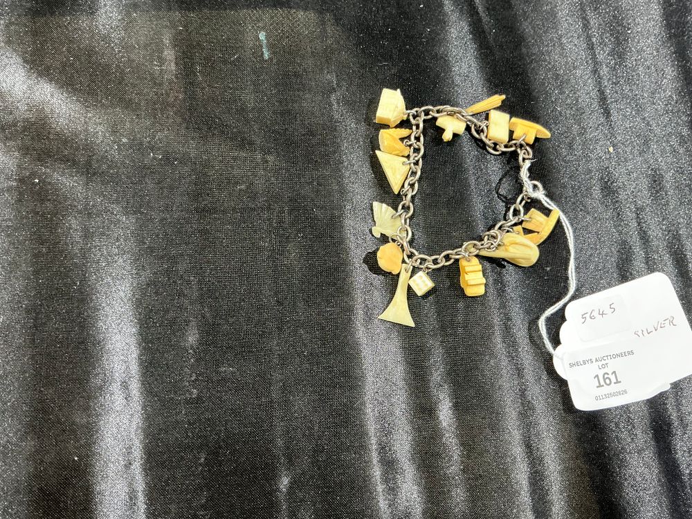 Lot 161: Vintage Silver Charm Bracelet with Carved Figural Bone Charms