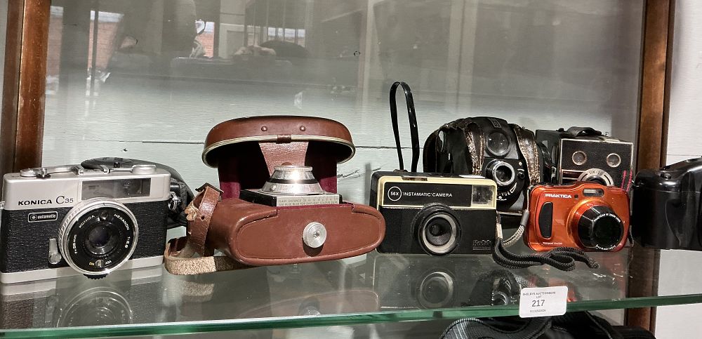 Lot 217: A Collection of Seven Vintage and Modern Cameras Including Konica, Kodak, and Praktica Models