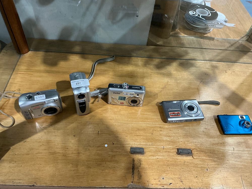 Lot 227: A Collection of Vintage Compact Digital Cameras Including Olympus, Vivitar, and Casio