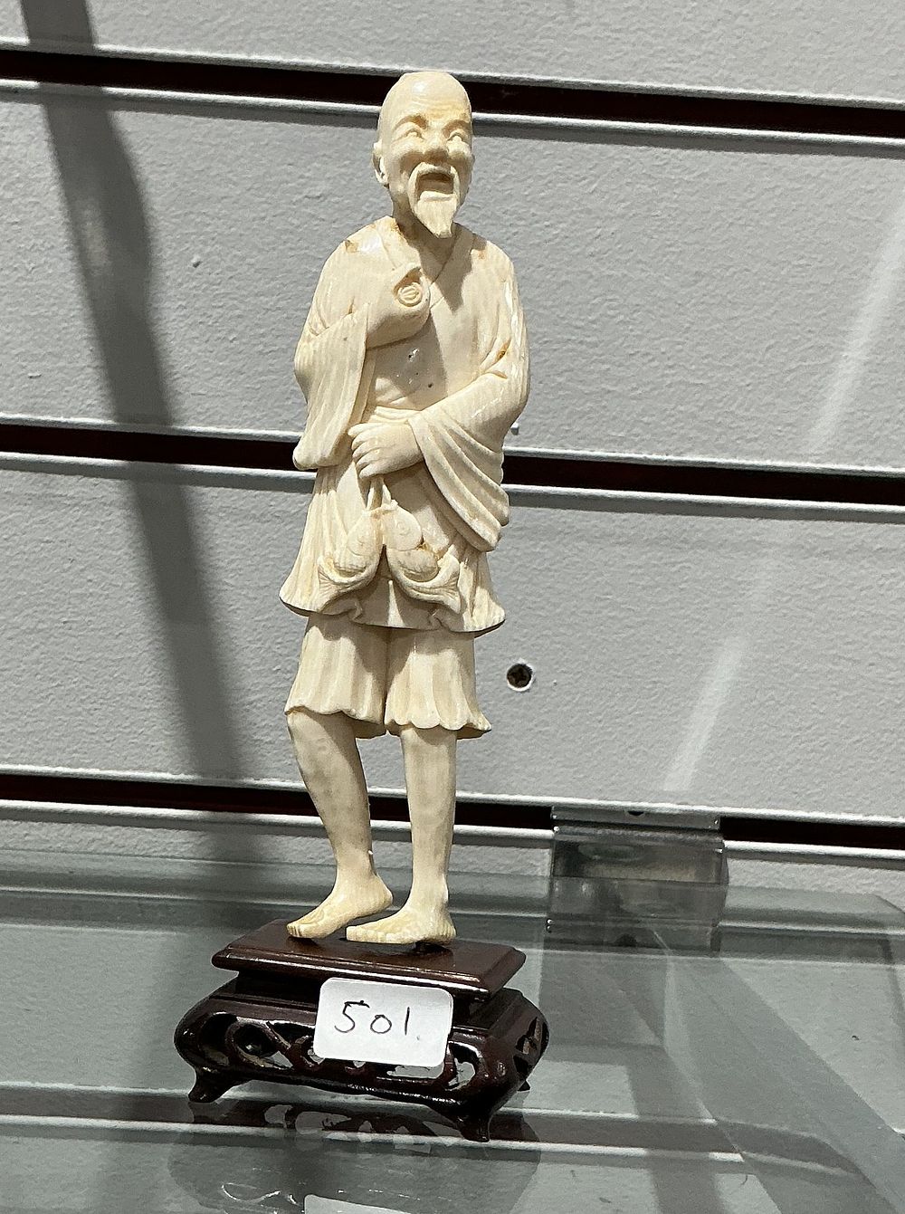 Lot 310: A carved bone  figure of a fisherman, 20th Century or later