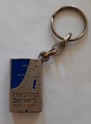 מחזיק מפתחות צורת קופת קרן קיימת לישראל (קק"ל). גודלו של דימוי הקופה כ 4X2.5 ס"מ