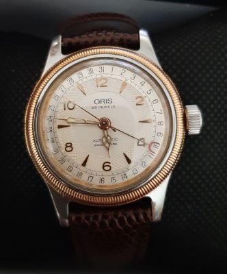 ORIS - שעון אוריס אוטומטי גב שקוף לצפייה במנגנון. מחוג מיוחד המראה את התאריך. קוטר 36 מ"מ. 