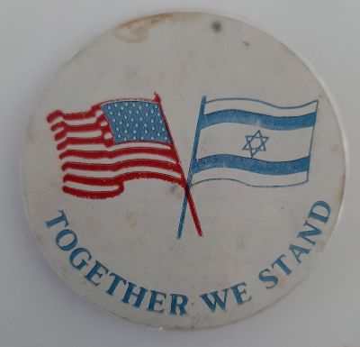 סיכה ישנה עם דגלי ארה"ב וישראל והכיתוב "עומדים יחד". קוטר 5.5 ס"מ.
