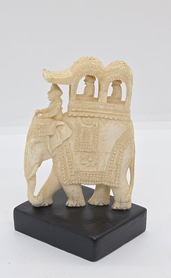 מזרח רחוק. גילוף בשן - הב. כנראה מהודו. 
פיל ועל גבו "כרכרה" עם 2 אנשים בפנים והנהג על צוואר 