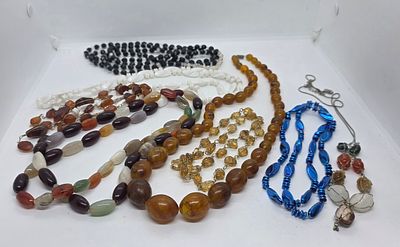 לוט של שרשראות אופנה מיוחדות . השרשראות שמוצגות על היד מאבנים טבעיות. 
אחת עינבר , אבנינאגת 