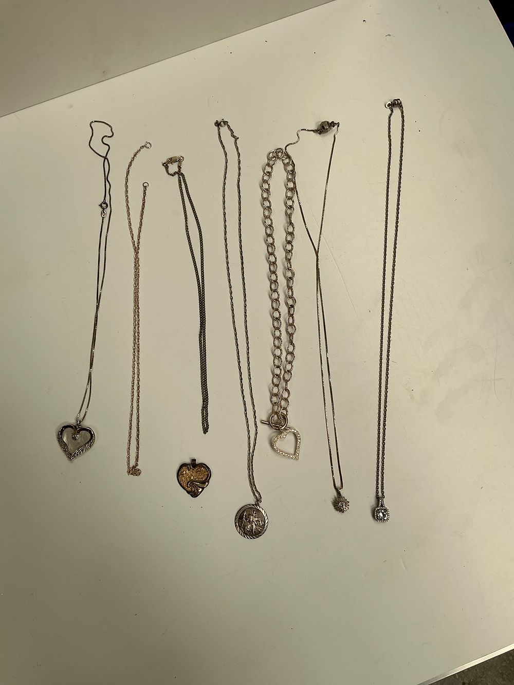 Lot 327: A Collection of Sterling Silver and Silver-Toned Pendants...