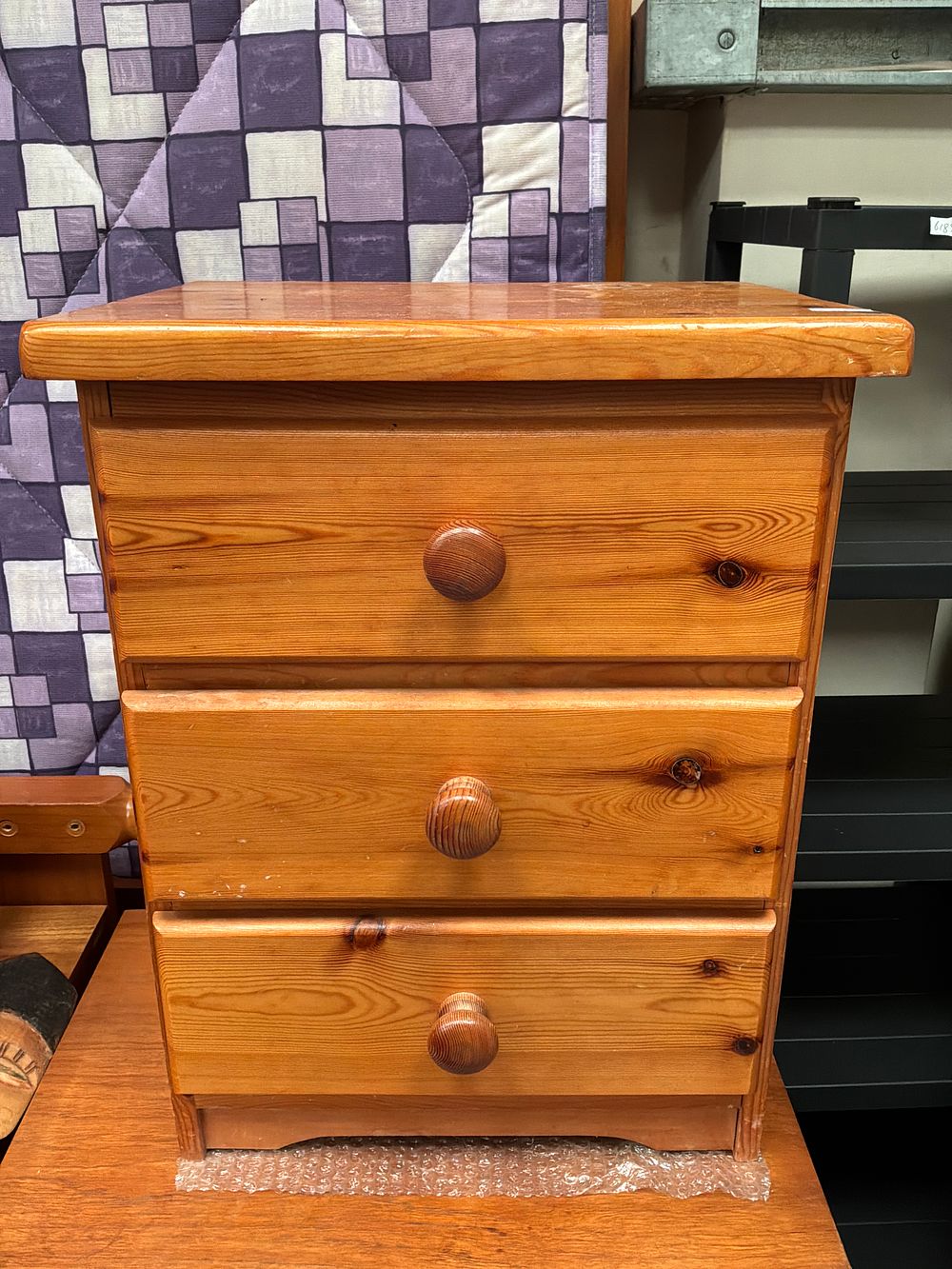 Lot 445: A contemporary pine three-drawer bedside chest in a...