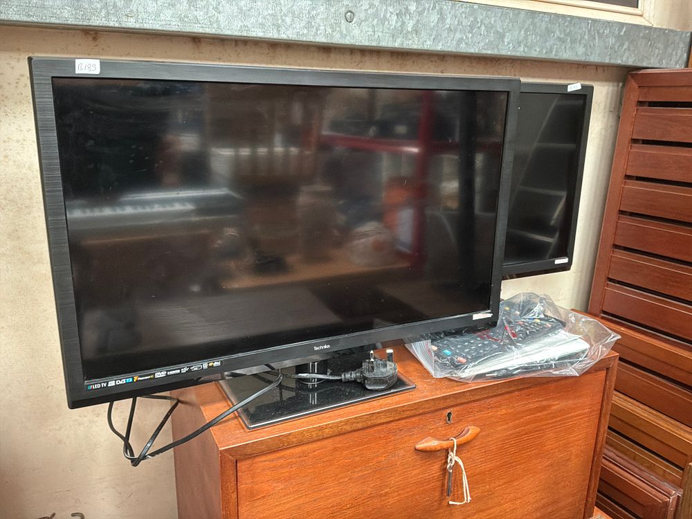 Lot 453: Two Technika 24-inch LED TVs with Built-in DVD...