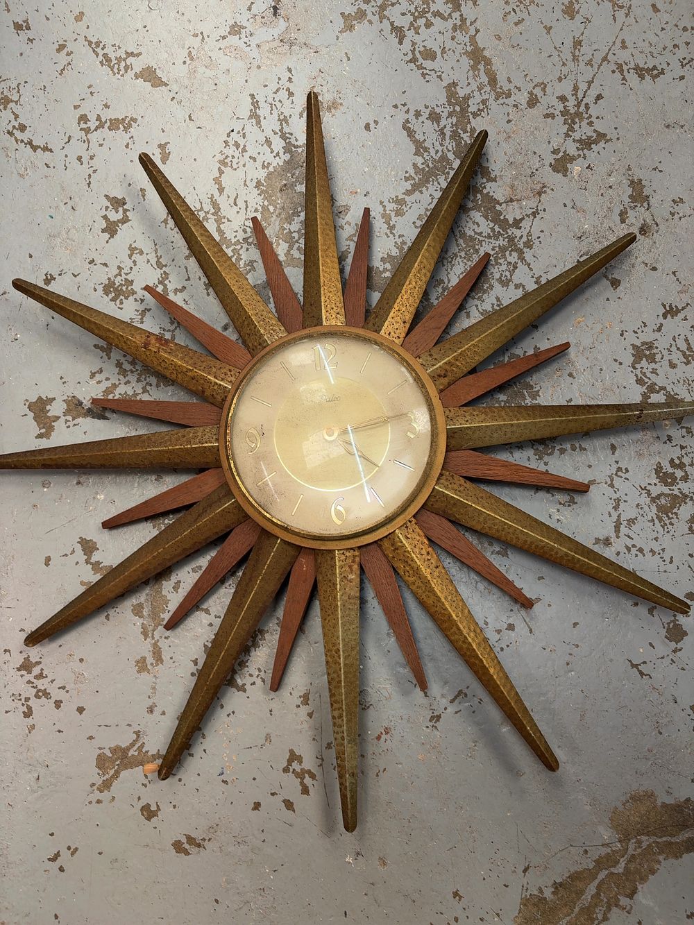 Lot 250: A mid-century modern Paico sunburst wall clock in gilt metal and wood