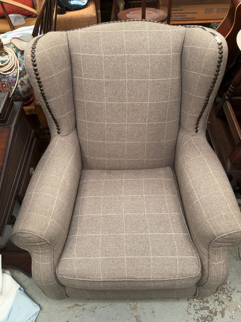 Lot 295: A contemporary Queen Anne style wingback armchair in windowpane check upholstery
